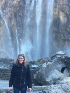 woman with narcolepsy in front of a waterfall in winter