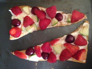 fruit pizza with strawberries, apples, grapes, etc 