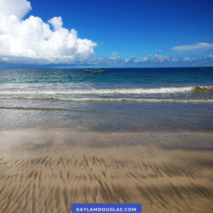 incredible blue sky with fluffy clouds, smooth beach, and blue sea 