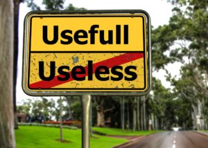 Road sign with word "useless" crossed out and useful on top