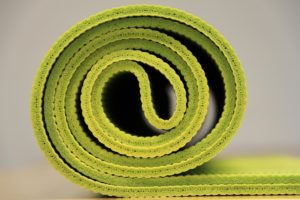 rolled up green yoga mat