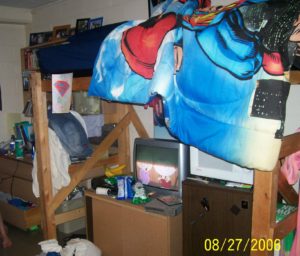 messy dorm room with loft bed