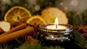 candle, cinnamon, and orange slices