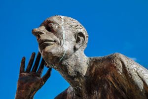 bronze sculpture with hand up to ear for active listening