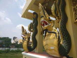 two burmese python dragon creatures carved into a structure