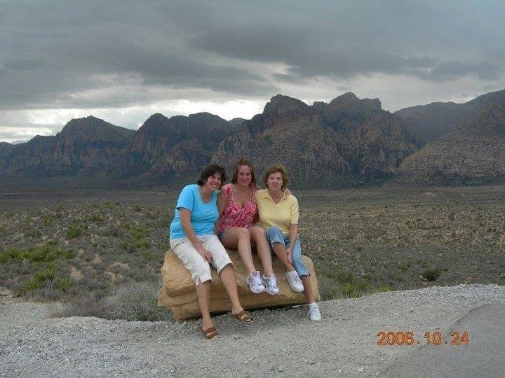 Jill Hetrick with her mom and sister with a mountainous background