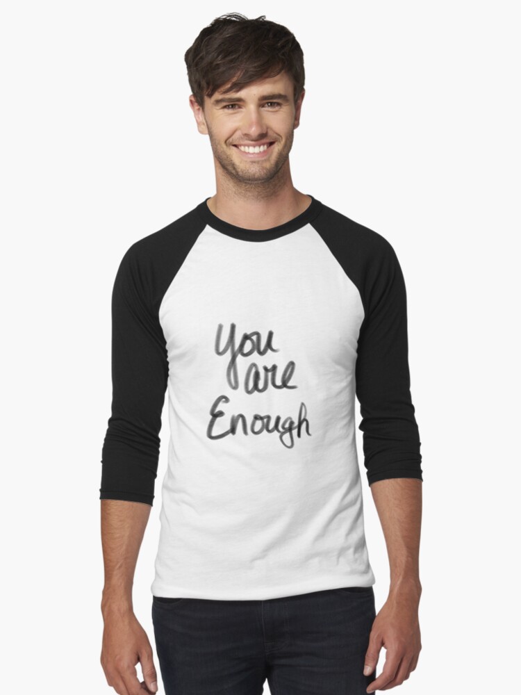 A cute guy wearing a long sleeve shirt that says, "You are Enough" 