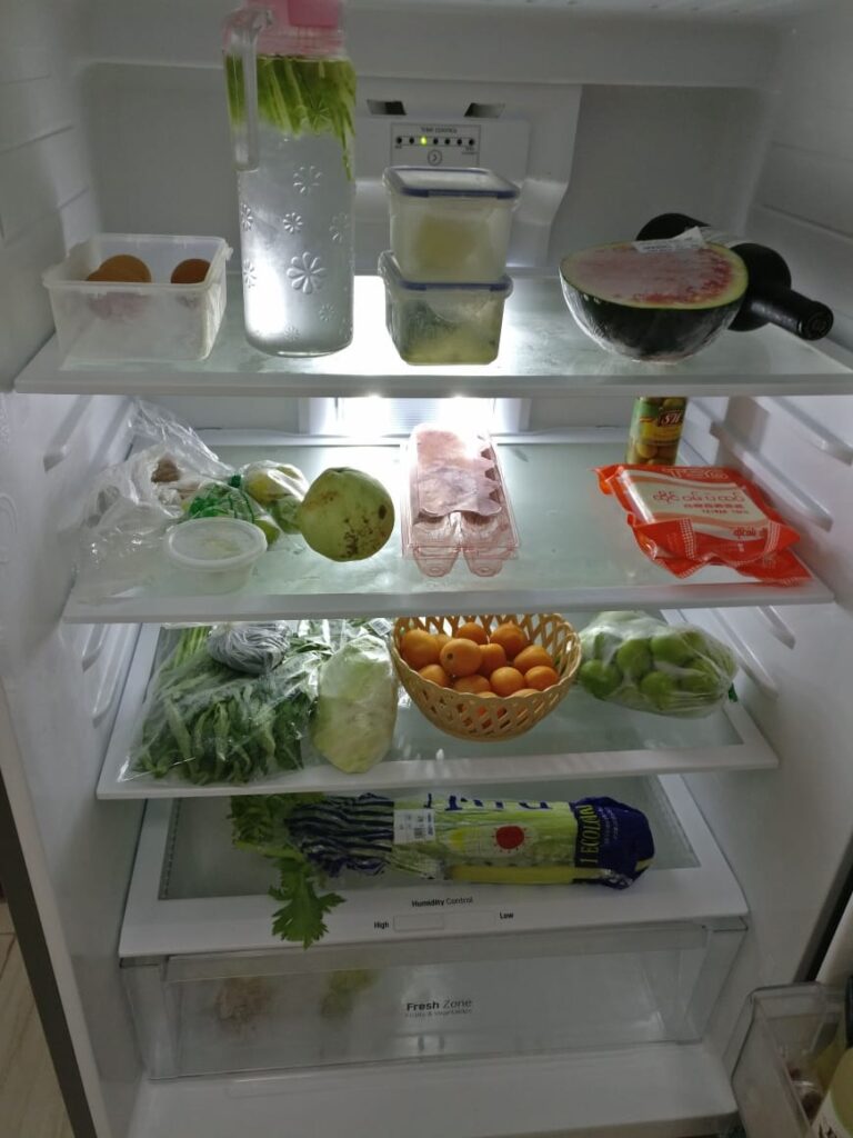 inside of a fridge with lots of narcolepsy diet food like vegetables, fruit, tofu, and no junk food