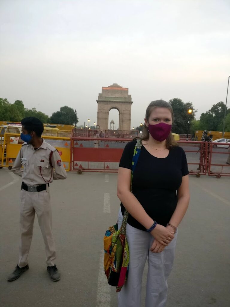 Kayla wearing a mask in front of the India Gate in Delhi